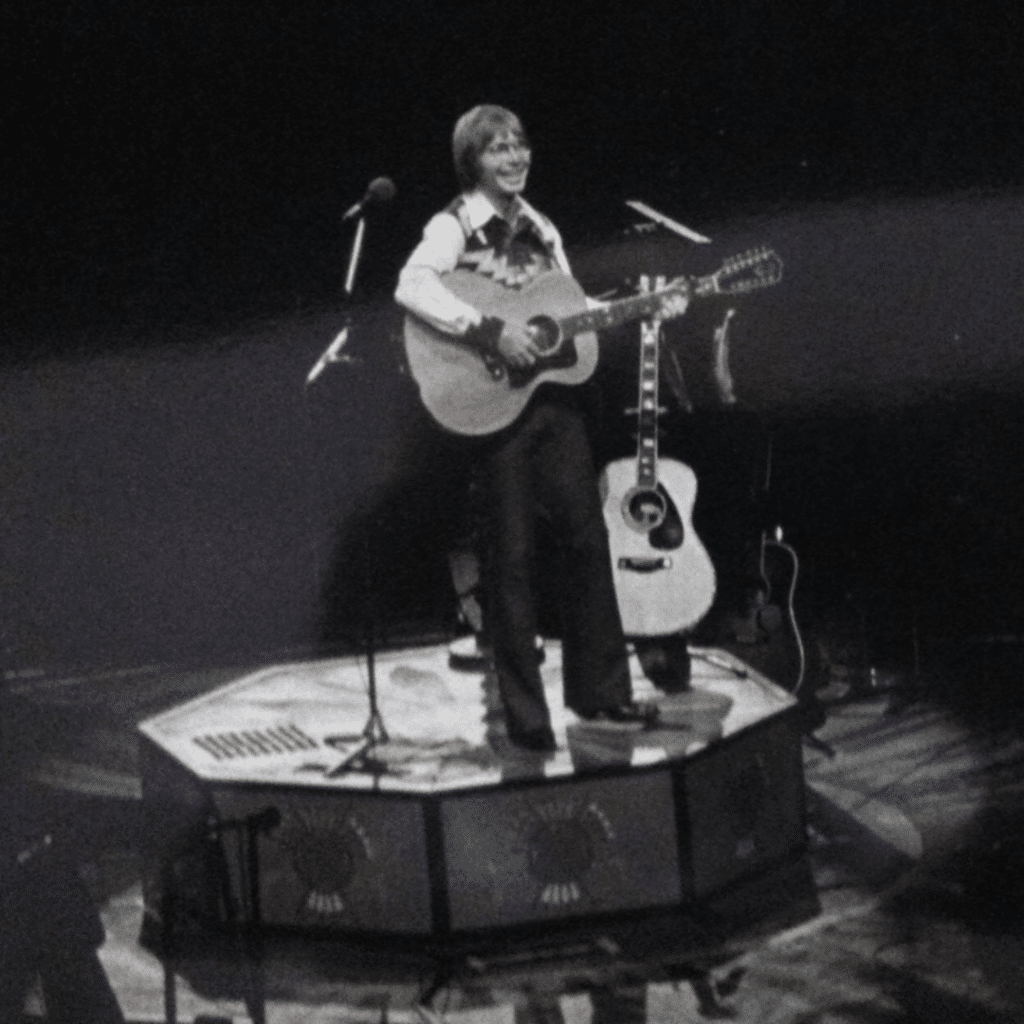 John Denver performs at the BJCC Coliseum in 1976.